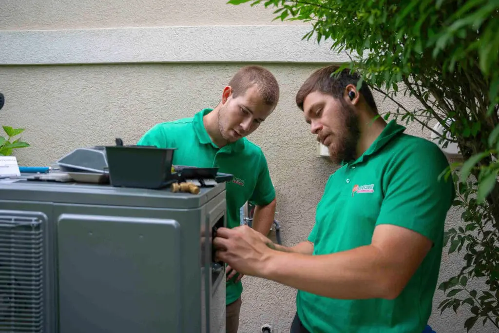 HVAC technicians installing air conditioning system in Radcliff, KY