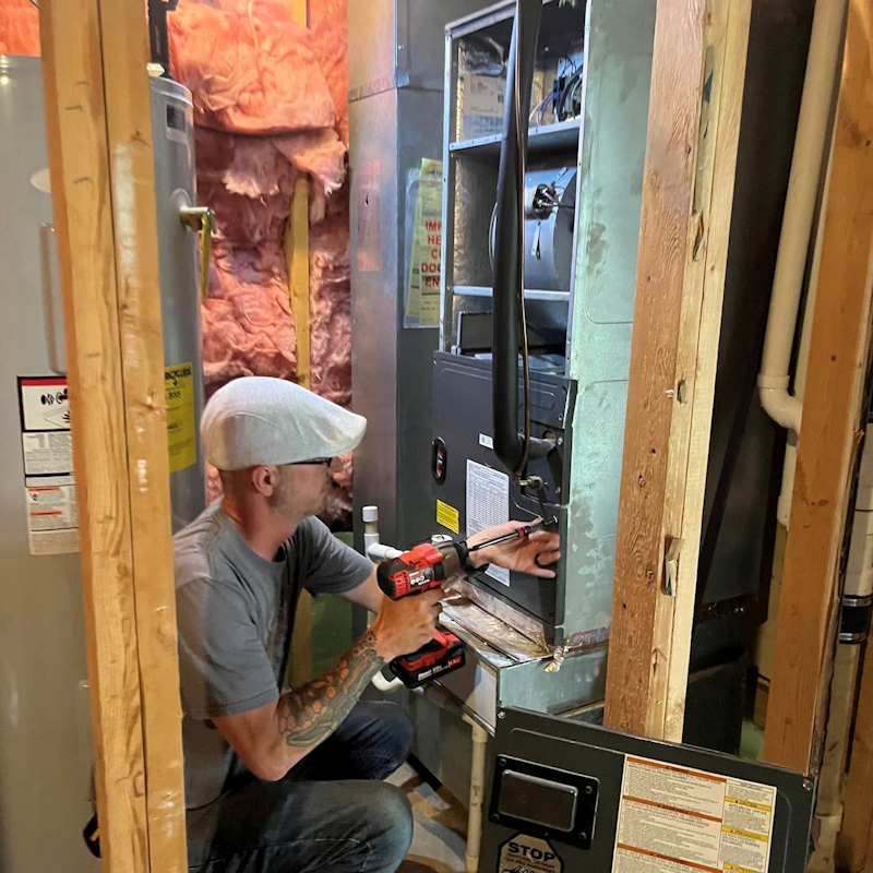 Ireland Heating and Cooling technician replacing a residential furnace